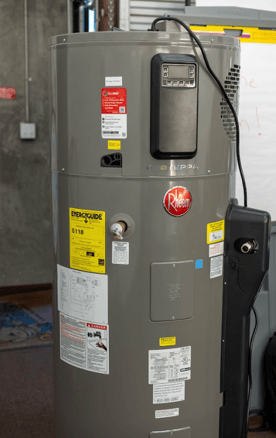 The image shows a picture of a Rheem heat pump water heater.