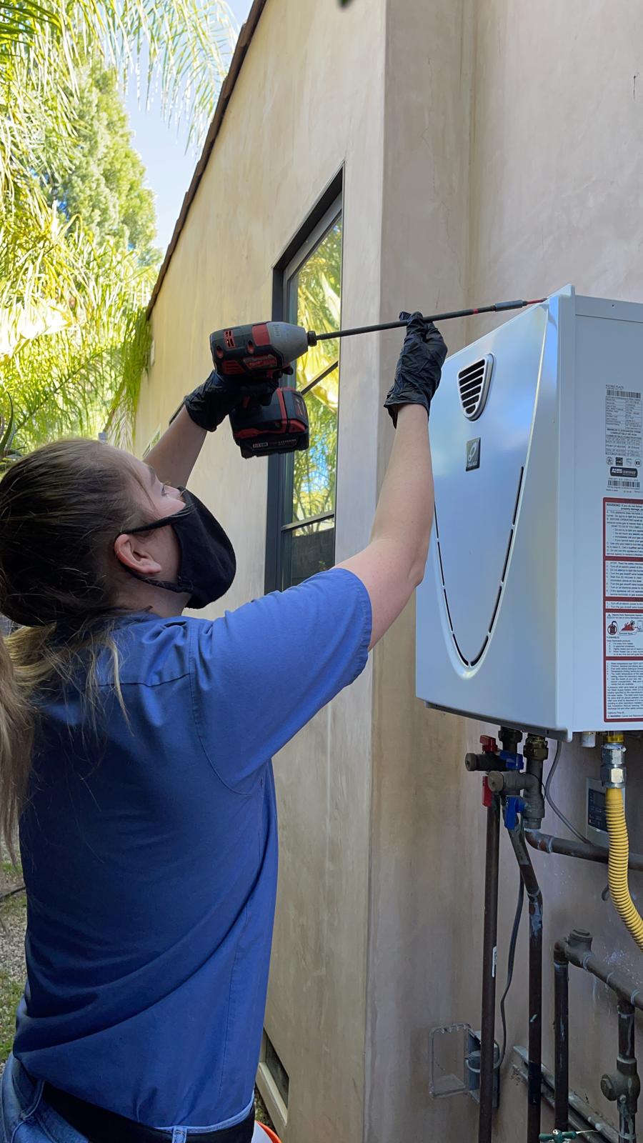 Monkey Wrench Plumbing technician servicing tankless water heater
