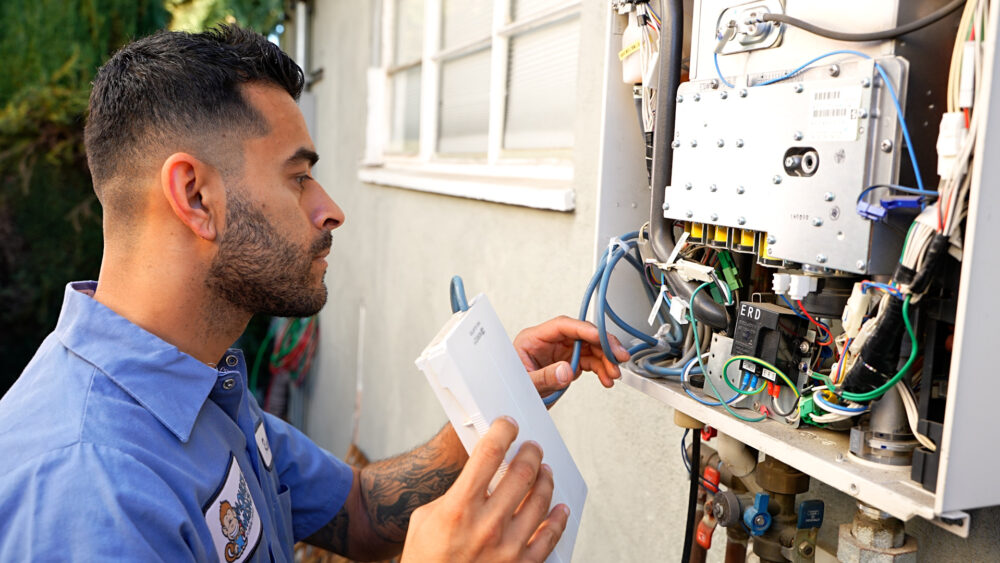 plumber working on noritz tankless water heater in Los Angeles
