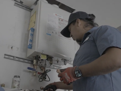 A Monkey Wrench technician finishing up a tankless water heater installation.