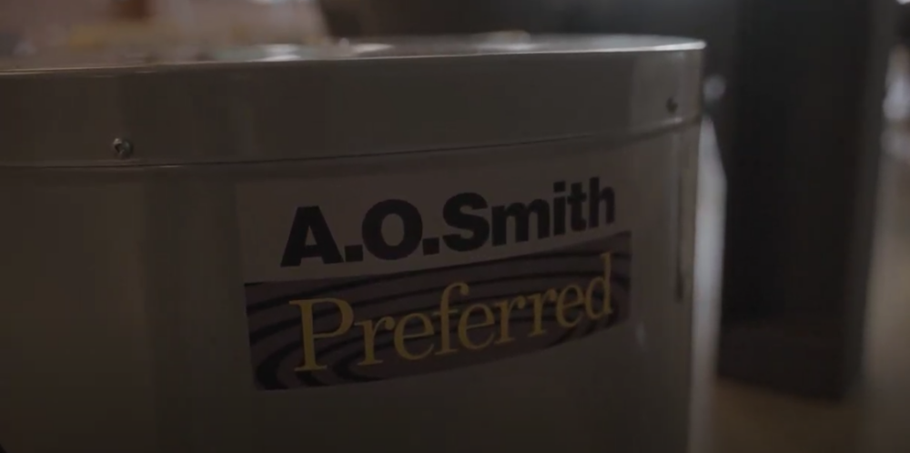The image shows a close up view of an A.O. Smith conventional water heater.